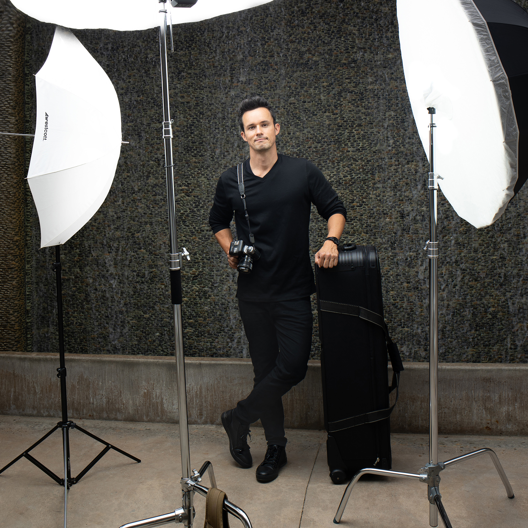 Photographer With Light Stands and Camera